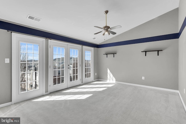 unfurnished room featuring plenty of natural light, carpet, visible vents, and french doors