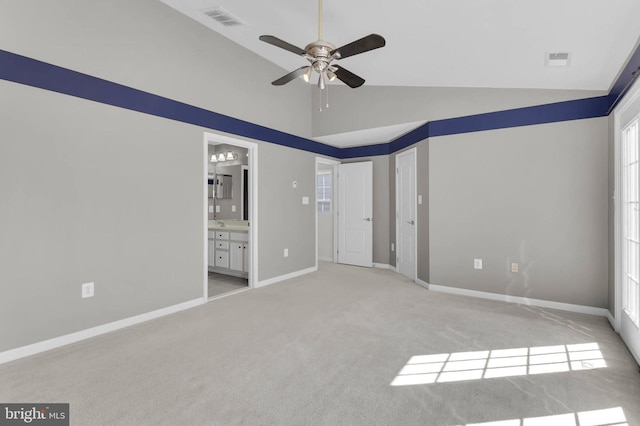 unfurnished bedroom featuring baseboards, visible vents, ensuite bathroom, and light colored carpet