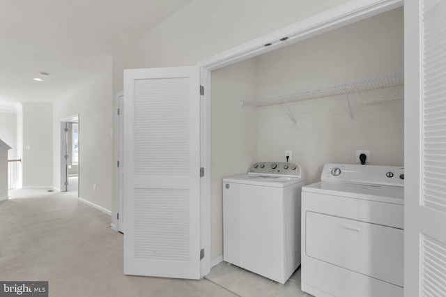 laundry room with laundry area, baseboards, and separate washer and dryer