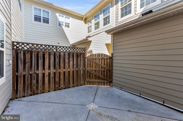 view of patio featuring a gate and fence