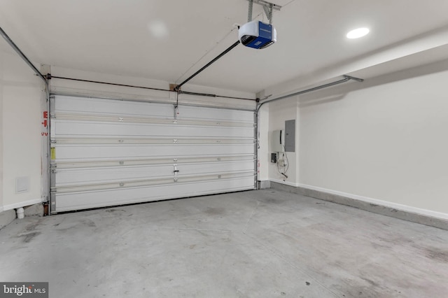 garage with electric panel, baseboards, and a garage door opener