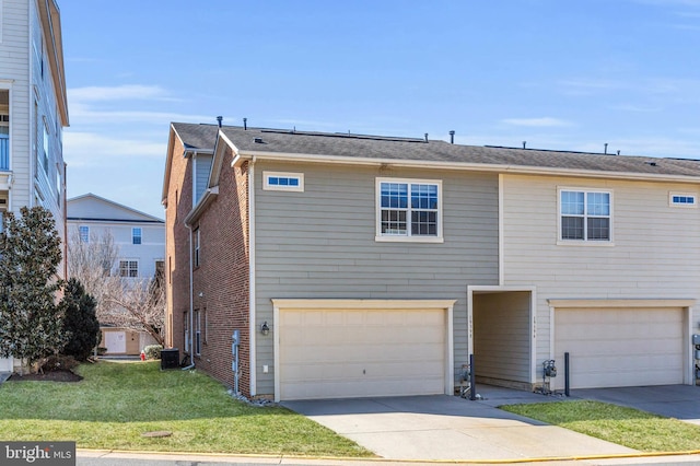 view of front facade featuring an attached garage, driveway, a front yard, and brick siding