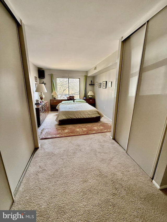 bedroom featuring carpet floors and visible vents