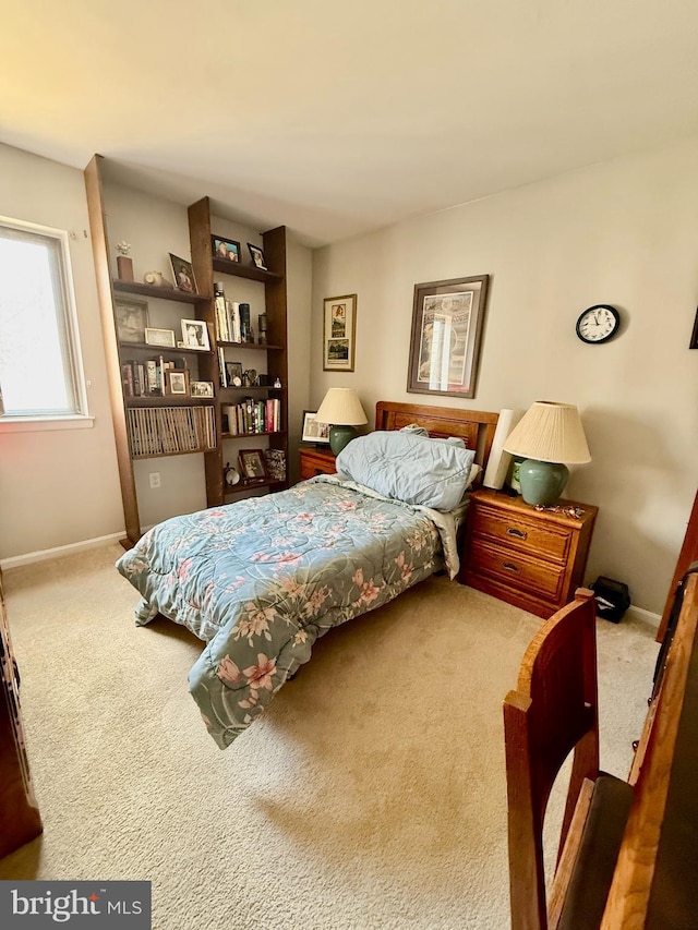 carpeted bedroom with baseboards