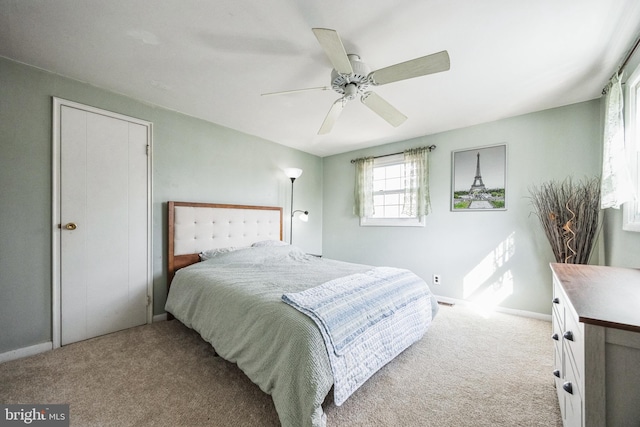 bedroom with ceiling fan, carpet floors, and baseboards