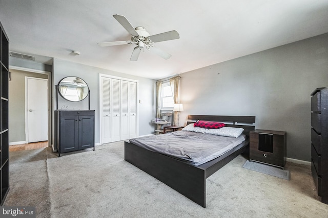 carpeted bedroom featuring a ceiling fan, baseboards, visible vents, and a closet