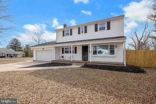 traditional-style home with a chimney, covered porch, fence, a garage, and driveway