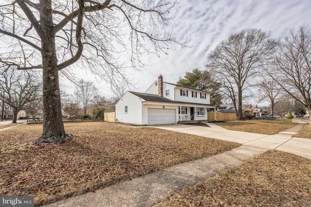 view of front facade with a garage, covered porch, fence, driveway, and a chimney