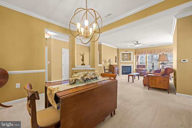 dining room featuring visible vents, baseboards, ornamental molding, a glass covered fireplace, and light colored carpet