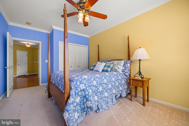 carpeted bedroom featuring baseboards, ornamental molding, and a ceiling fan