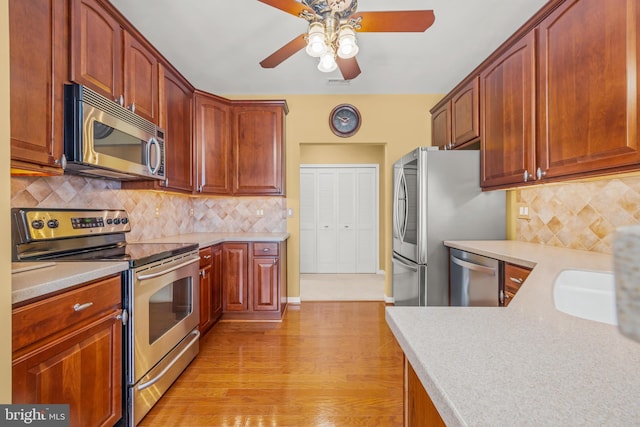 kitchen with tasteful backsplash, visible vents, ceiling fan, light countertops, and appliances with stainless steel finishes