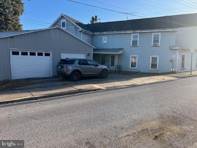 townhome / multi-family property featuring driveway and an attached garage