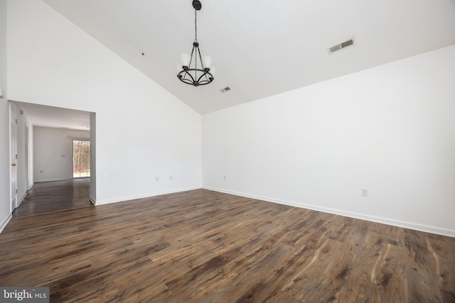 empty room featuring baseboards, visible vents, high vaulted ceiling, an inviting chandelier, and dark wood-type flooring