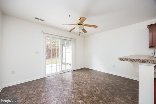 interior space with a ceiling fan, baseboards, and visible vents