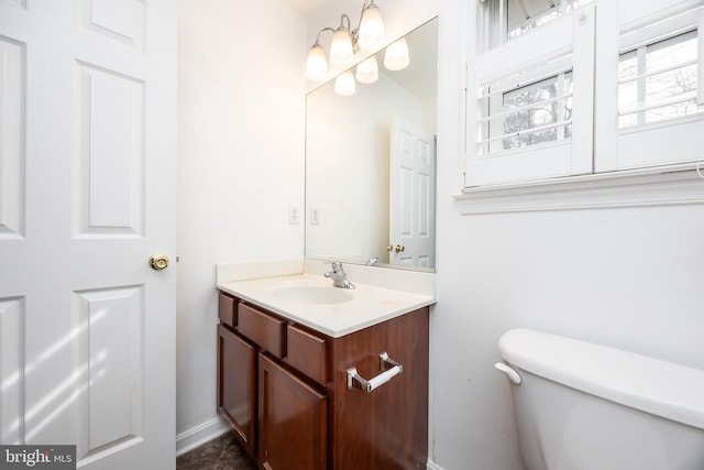 half bath with vanity and toilet