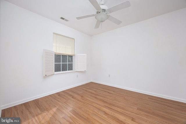 empty room with visible vents, baseboards, light wood-style flooring, and a ceiling fan