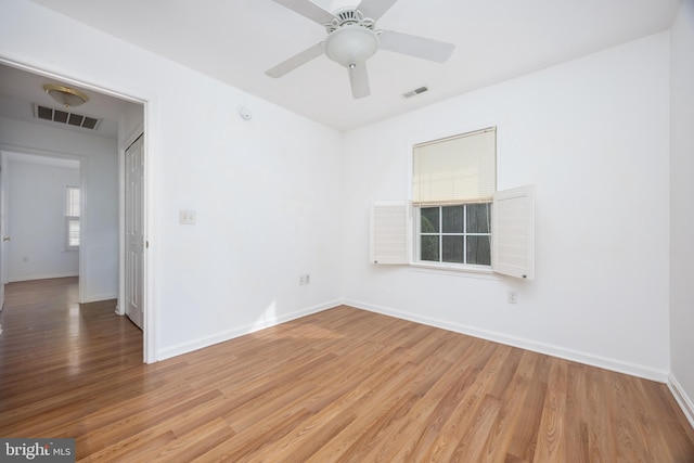 unfurnished room featuring visible vents, baseboards, and light wood-style flooring