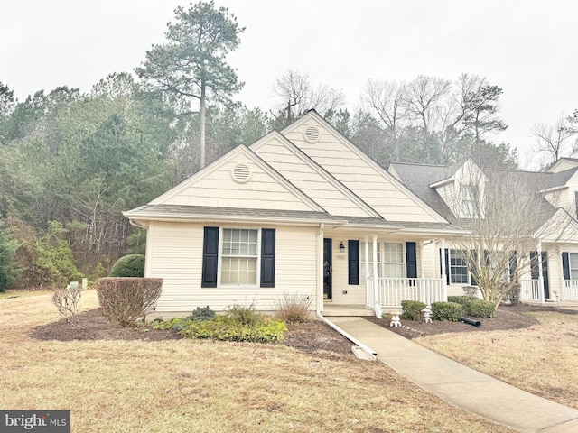 view of front of property with covered porch and a front lawn