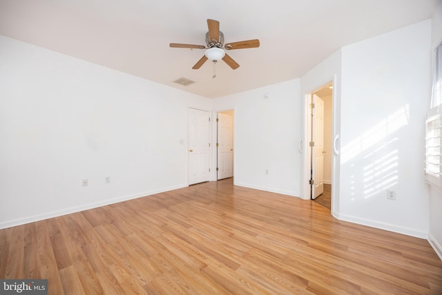 unfurnished room with visible vents, baseboards, light wood-style floors, and a ceiling fan