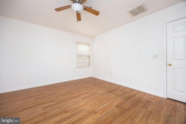 unfurnished room with a ceiling fan, light wood-style flooring, baseboards, and visible vents