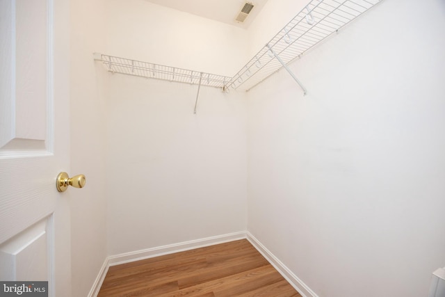 walk in closet with light wood-type flooring and visible vents