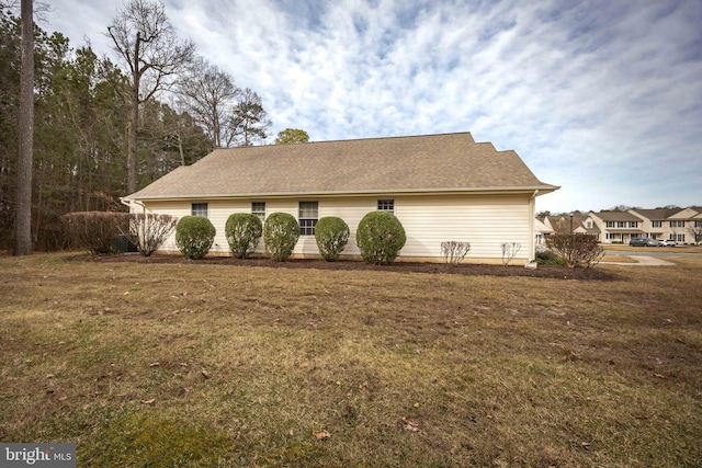 view of property exterior featuring a lawn