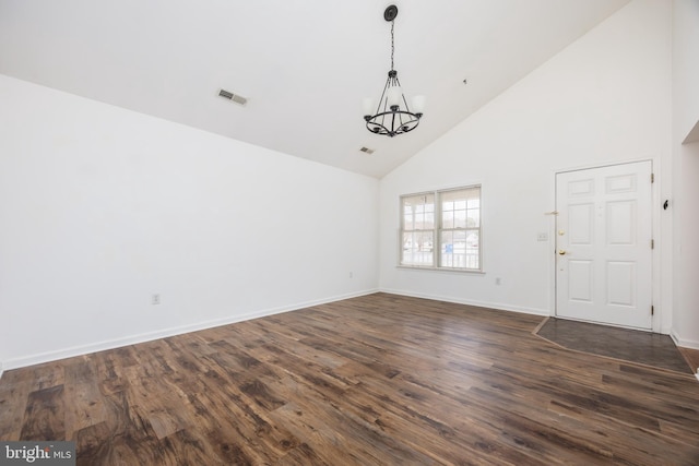 interior space featuring a chandelier, visible vents, high vaulted ceiling, and dark wood-style flooring