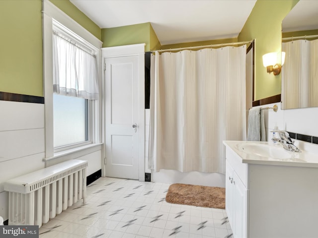 full bathroom featuring shower / bathtub combination with curtain, vanity, and radiator