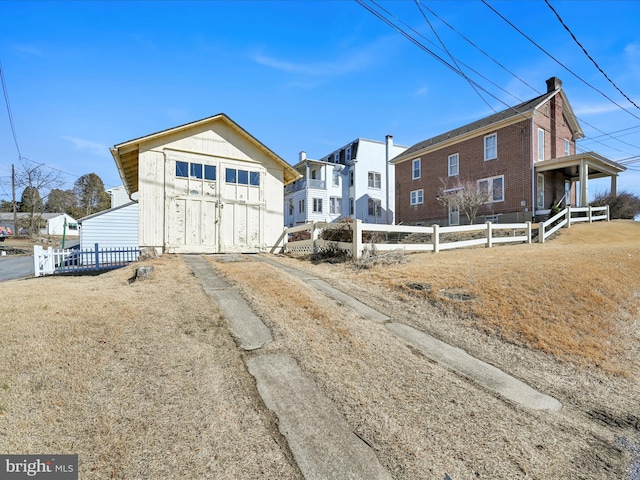 exterior space featuring an outbuilding, fence, and a shed