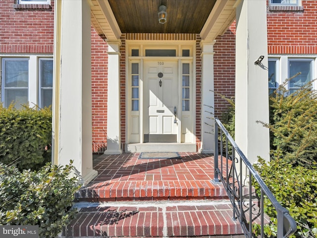 view of exterior entry with brick siding