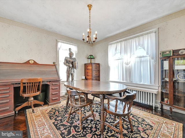 dining room with radiator, wallpapered walls, a chandelier, and dark wood-type flooring