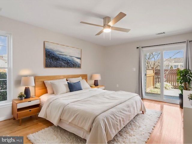 bedroom featuring access to exterior, visible vents, ceiling fan, and light wood-style flooring