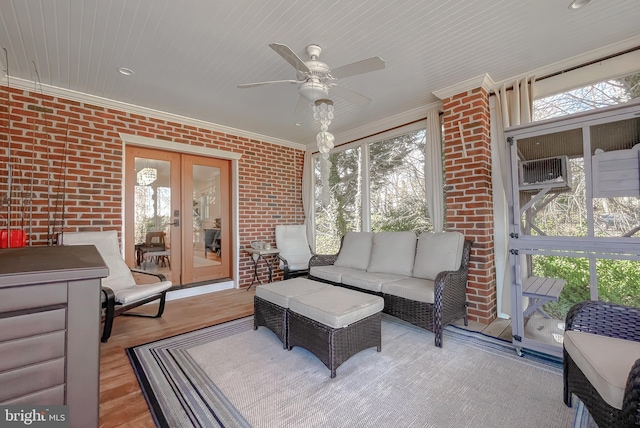 sunroom featuring ceiling fan and french doors