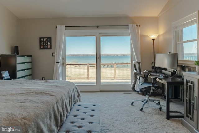 carpeted bedroom featuring vaulted ceiling, multiple windows, and access to exterior