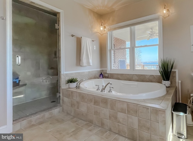 full bathroom with a ceiling fan, a stall shower, a garden tub, and tile patterned floors