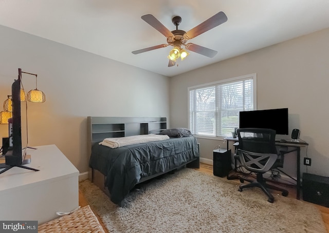 bedroom with ceiling fan and baseboards