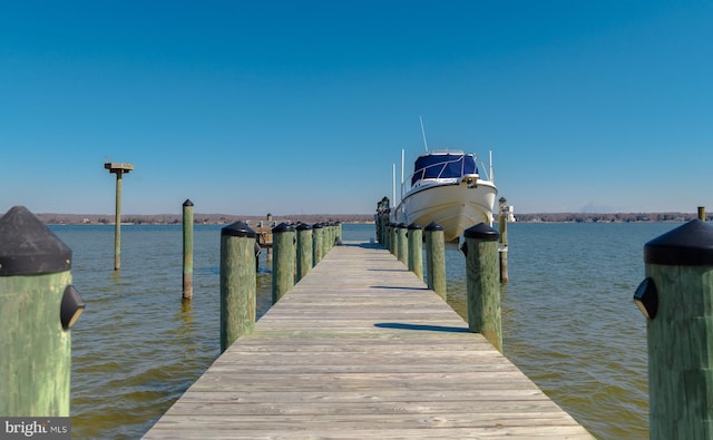 dock area with a water view and boat lift