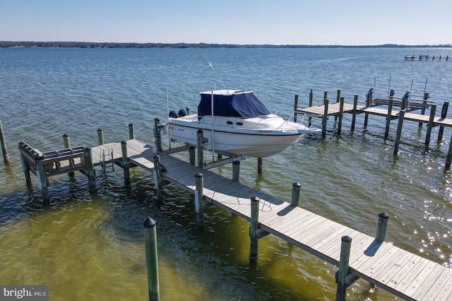 dock area with a water view and boat lift