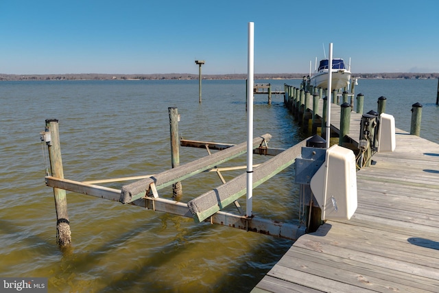 view of dock featuring a water view and boat lift