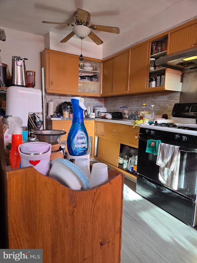 kitchen featuring a ceiling fan, gas stove, decorative backsplash, and open shelves