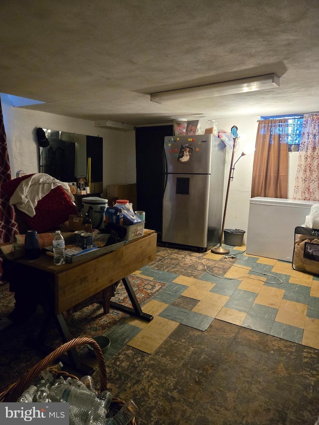 recreation room featuring a textured ceiling