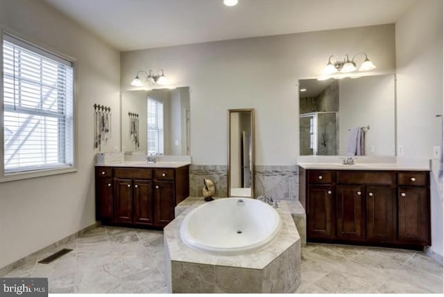 42578 Dreamweaver Dr, Brambleton, VA 20148 - full bathroom with a sink, two vanities, a shower stall, visible vents, and a garden tub
