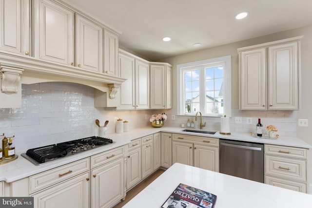 kitchen featuring tasteful backsplash, recessed lighting, stainless steel appliances, and a sink