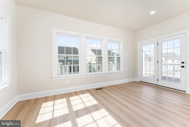 empty room featuring recessed lighting, visible vents, baseboards, and light wood-style floors