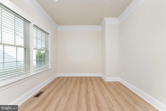 unfurnished room with crown molding, baseboards, visible vents, and light wood finished floors