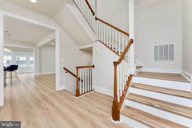 stairway with visible vents, recessed lighting, baseboards, and wood finished floors