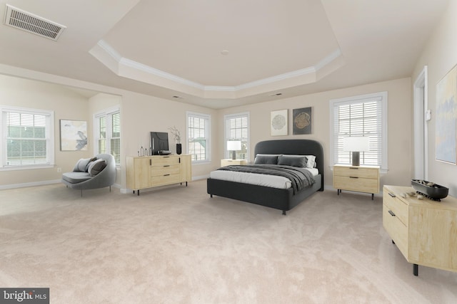 bedroom with a raised ceiling, ornamental molding, visible vents, and light carpet