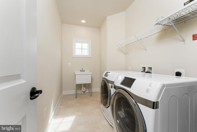 laundry area featuring laundry area, recessed lighting, washing machine and dryer, and baseboards