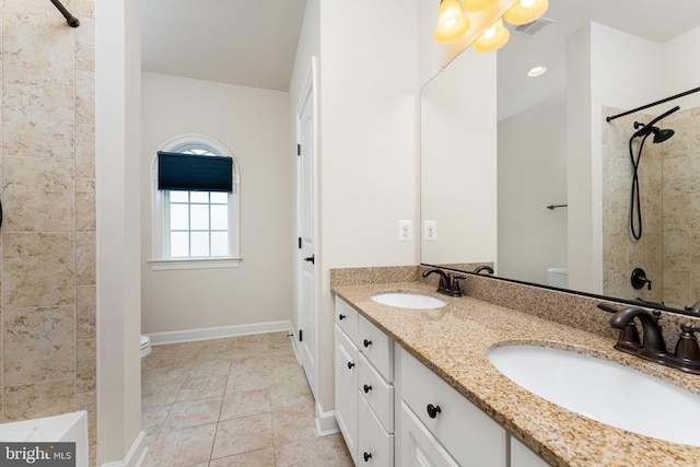 bathroom featuring tile patterned floors, toilet, visible vents, and a sink