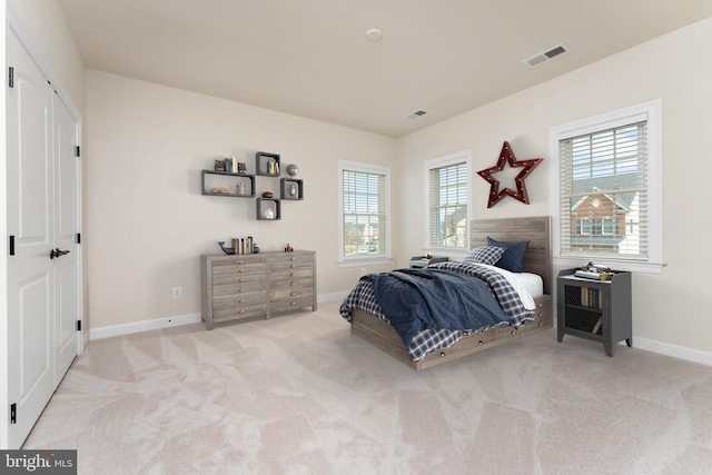 carpeted bedroom with baseboards and visible vents